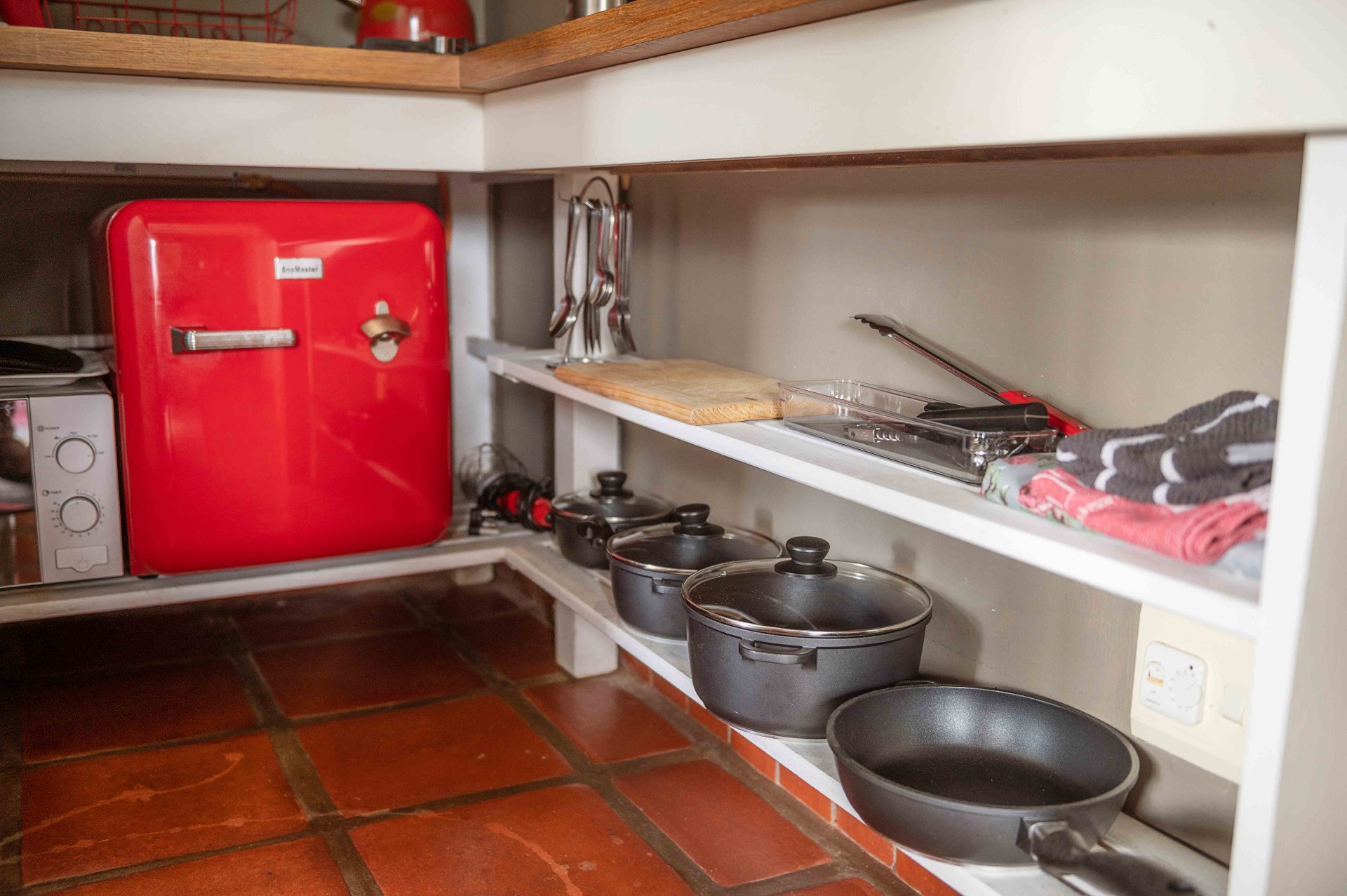 Kitchen shelves with pots, pans and utensils