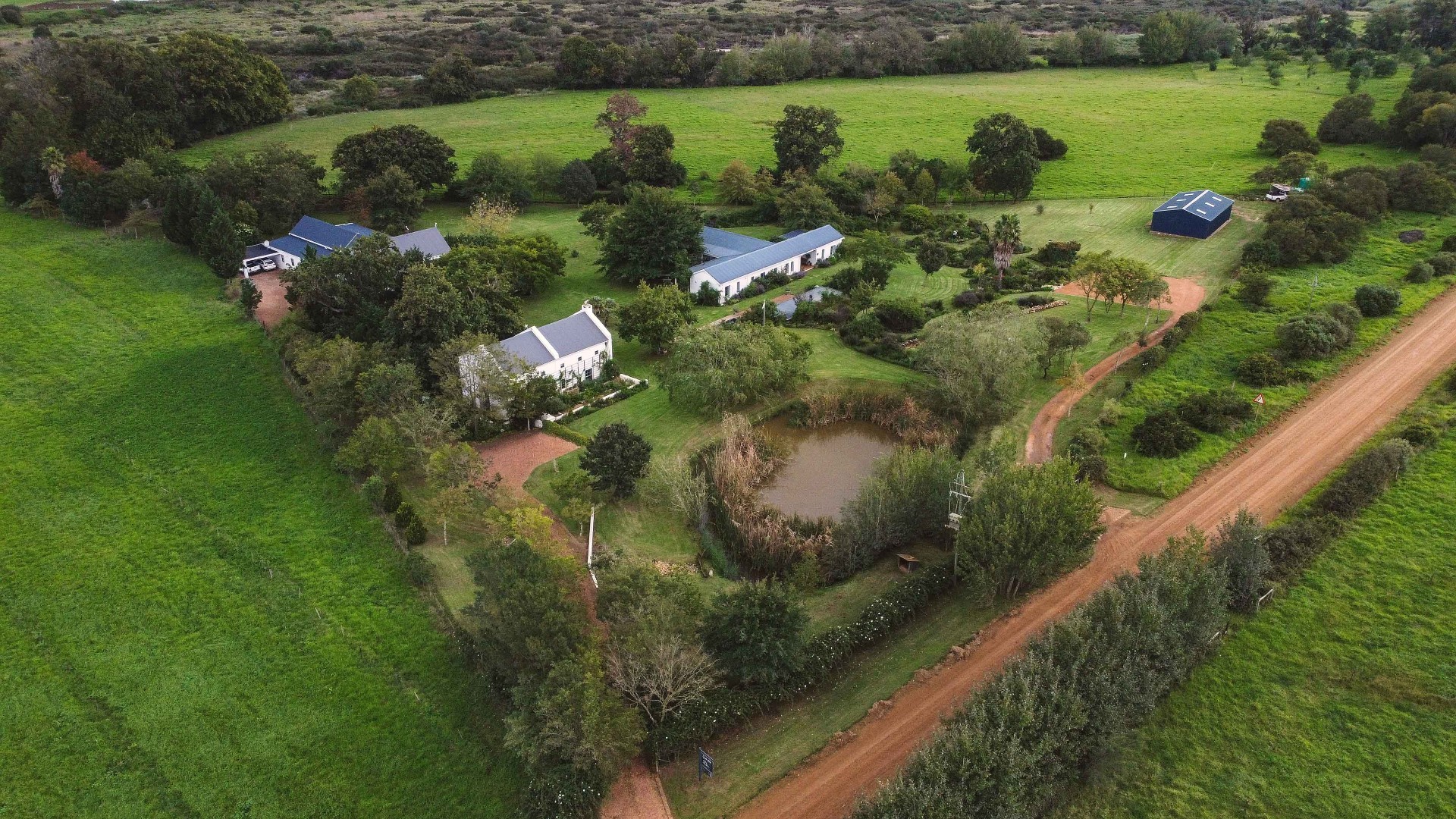 Aerial view of Oude Eik cottages, pond and green pastures